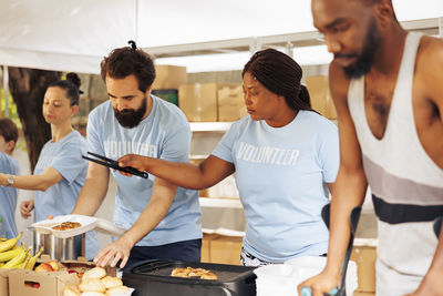 Side view of young woman preparing food in gym