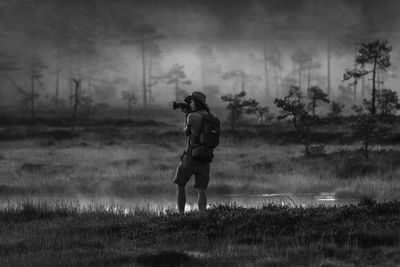 Full length of man standing on field against sky