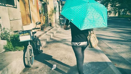 Woman walking on footpath
