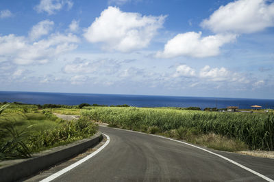 Road by sea against sky