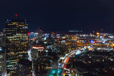 High angle view of illuminated buildings in city at night