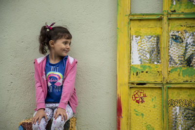 Girl standing against wall