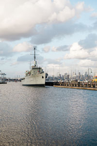 Commercial dock by sea against sky