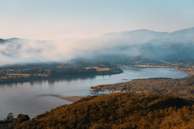 Scenic view of lake and mountains against sky