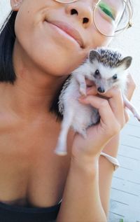 Portrait of woman holding small animal