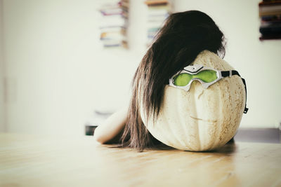 Close-up of girl looking down on table