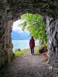 Rear view of woman standing on rock