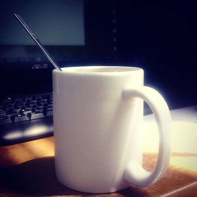 indoors, coffee cup, drink, refreshment, food and drink, saucer, coffee - drink, table, still life, coffee, cup, spoon, close-up, no people, freshness, beverage, tea cup, focus on foreground, empty, high angle view