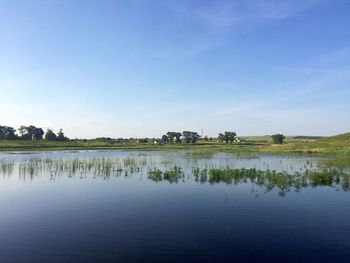 Scenic view of lake against blue sky