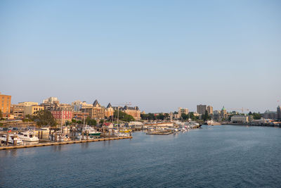 City by sea against clear sky