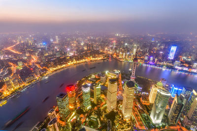 High angle view of illuminated city buildings at night