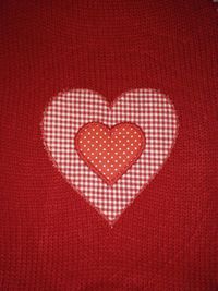 Close-up of heart shape on red background