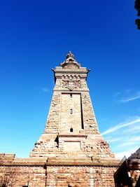 Low angle view of historic building against clear blue sky