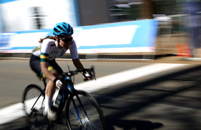 Side view of man riding bicycle on road