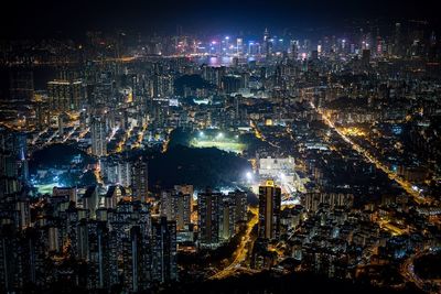 Illuminated cityscape against sky at night