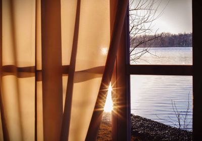 River seen through window with curtain