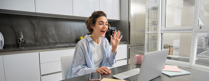 Young woman using mobile phone in office