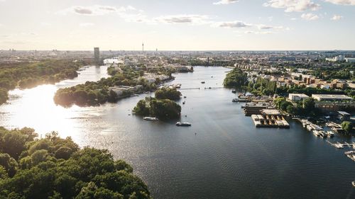 High angle view of river amidst buildings against sky