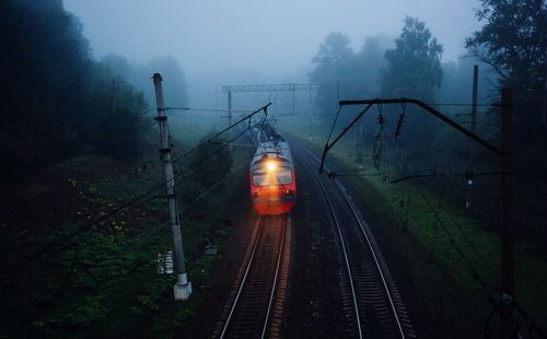 Train on railroad tracks during foggy weather