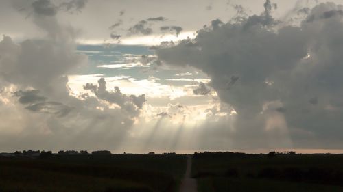 Panoramic view of agricultural field against sky during sunset