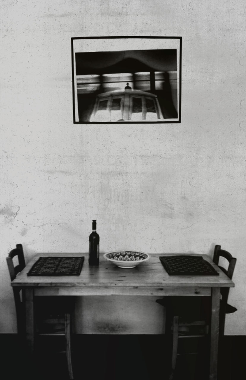 EMPTY CHAIR ON TABLE AT HOME