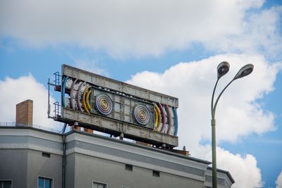 Low angle view of building against cloudy sky