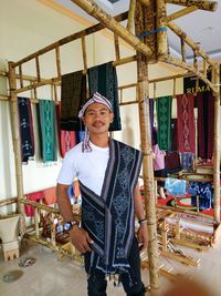 Portrait of smiling young man standing in market