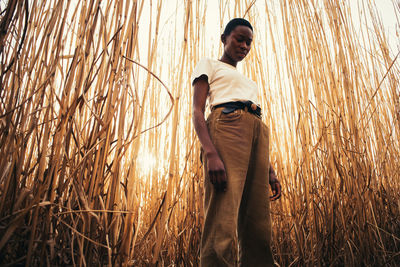 Low angle view of woman standing in field