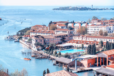 High angle view of townscape by sea against sky