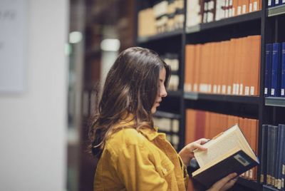 Rear view of woman reading book