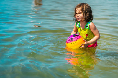 Girl playing with ball at beach