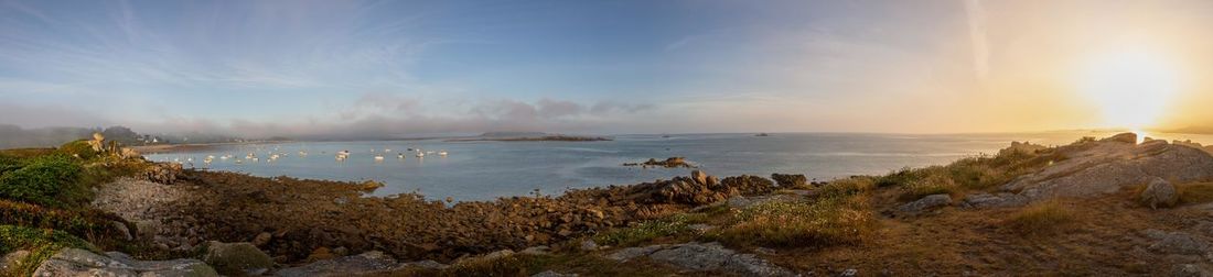 Panoramic view of sea against sky during sunset