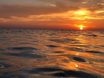 Scenic view of sea against romantic sky at sunset