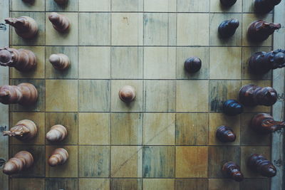 Directly above shot of wooden chess board with pieces