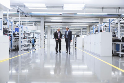 Two mangagers having a meeting at the shop floor of a factory