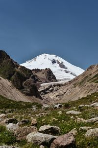 Scenic view of snowcapped mountains against clear blue sky