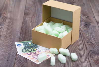 High angle view of candies in box on table