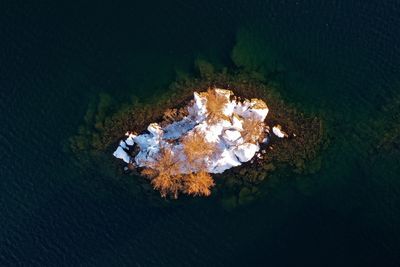 Aerial view of snowcapped mountains amidst water