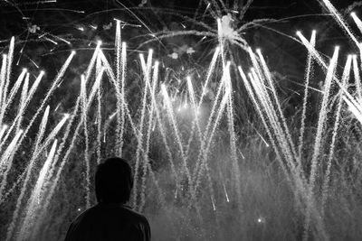 Low angle view of firework display at night