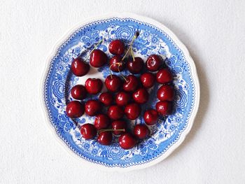 High angle view of strawberries in plate on table