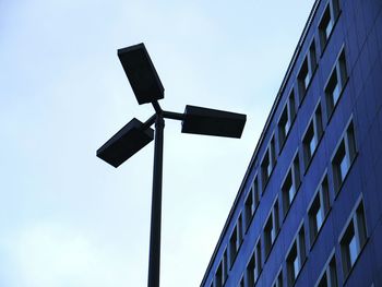 Low angle view of communications tower against clear blue sky