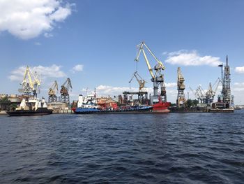 Commercial dock by sea against sky