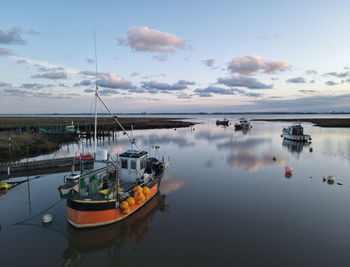 Sunset over boats in stone creek harbour, sunk island, east riding of yorkshire, uk