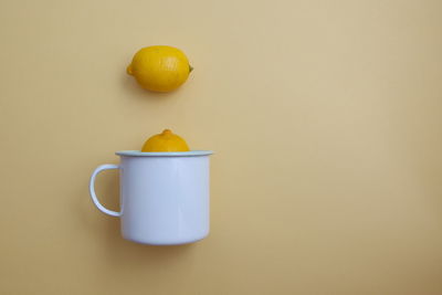 Close-up of drink against orange background