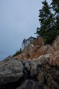 Low angle view of rocks on mountain against sky