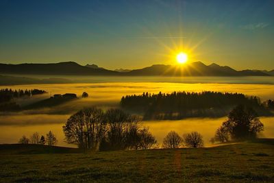 Scenic view of landscape against sky during sunset