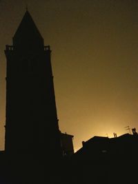 Low angle view of building against sky at sunset