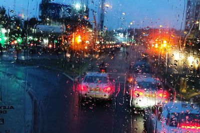 City street seen through wet glass window