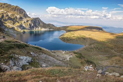 Scenic view of lake and mountains against sky