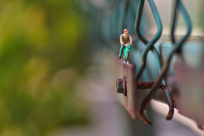 Close-up of figurine toy hanging on wood